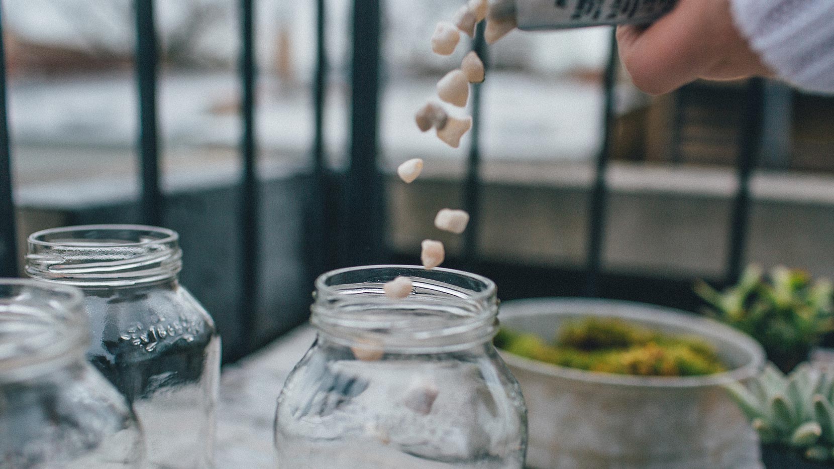 Put a layer of small rocks as base in clean jar